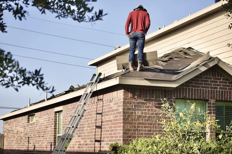 Professional roofer working on a residential roof in Belle Terre